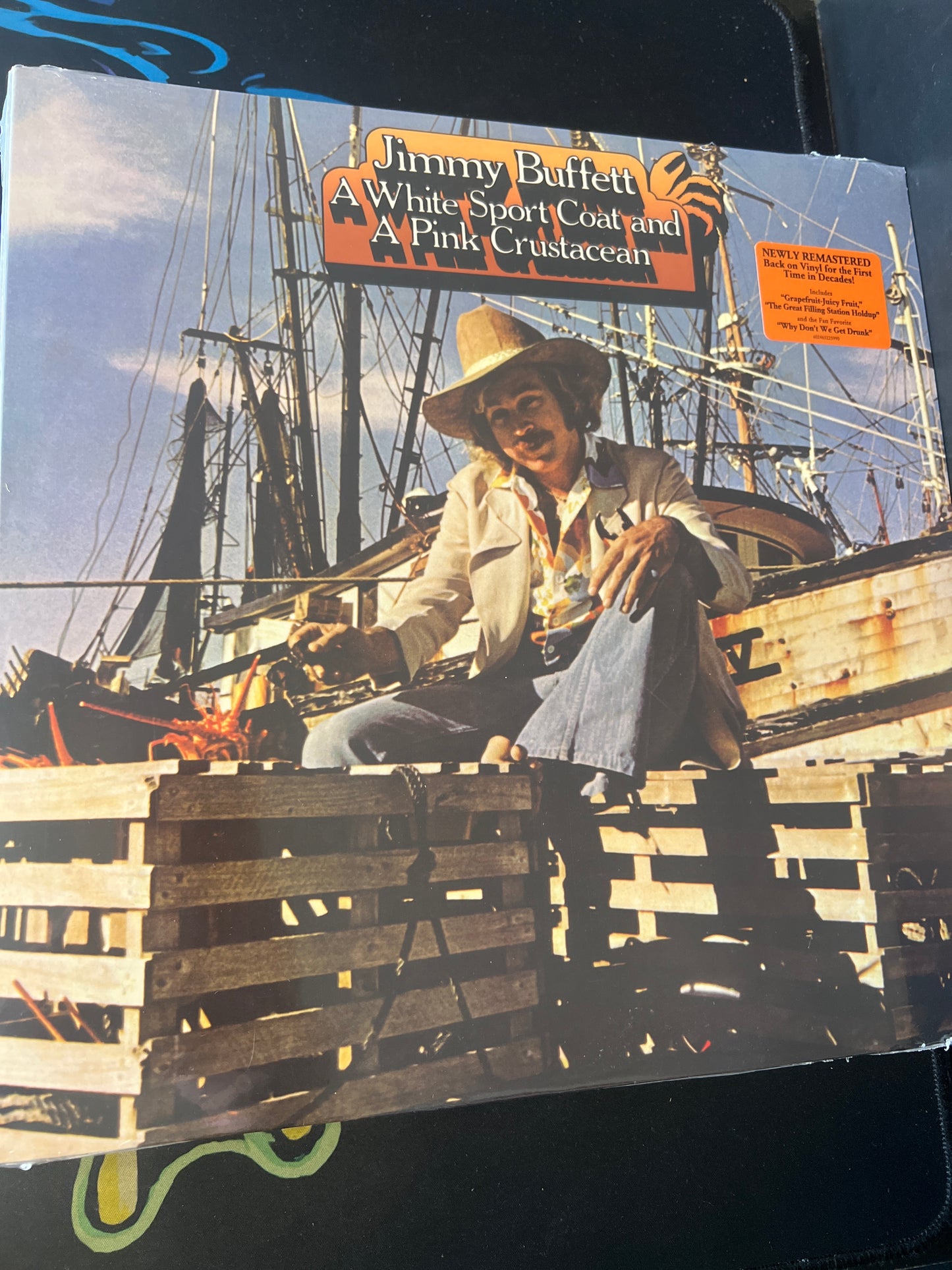 JIMMY BUFFETT - a white sport coat and a pink crustacean